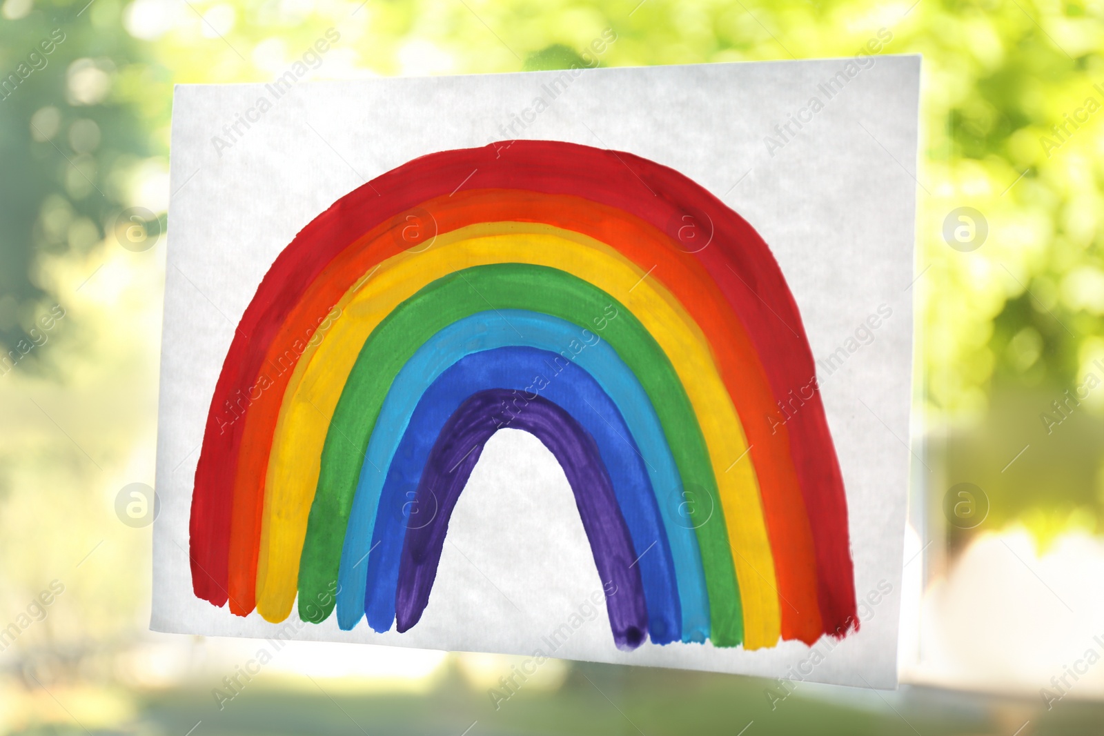 Photo of Picture of rainbow on window glass indoors, closeup. Stay at home concept