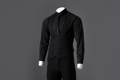 Photo of Male mannequin dressed in stylish black suit on grey background