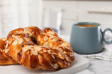 Delicious pastries and coffee on marble table, closeup