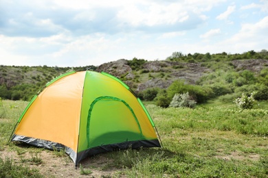 Small tourist tent in wilderness. Camping season