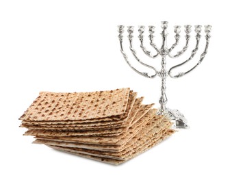 Photo of Matzo bread and menorah on white background