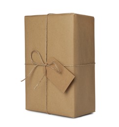 Photo of Parcel wrapped with kraft paper, twine and tag isolated on white