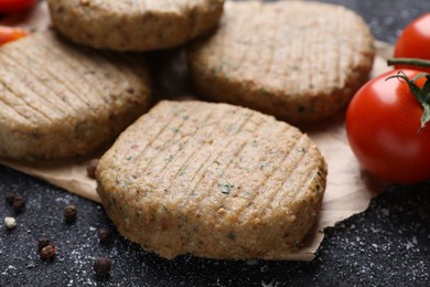 Tasty vegan cutlets and products on grey table, closeup