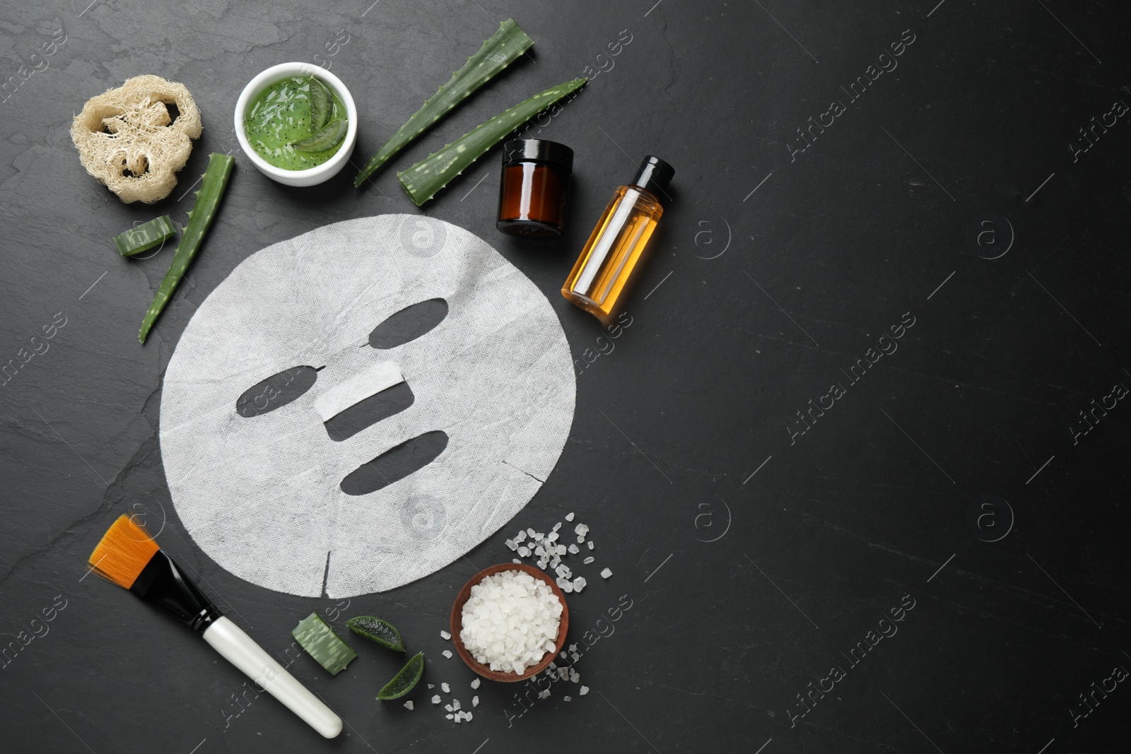 Photo of Flat lay composition with different cosmetic products and aloe on black table, space for text