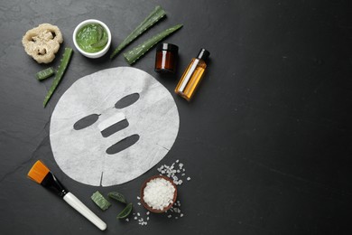 Flat lay composition with different cosmetic products and aloe on black table, space for text