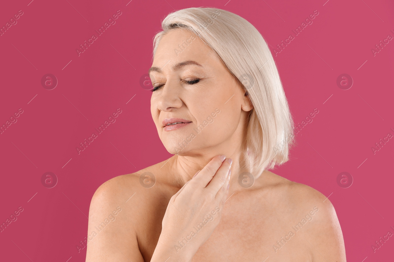 Photo of Portrait of beautiful mature woman on pink background