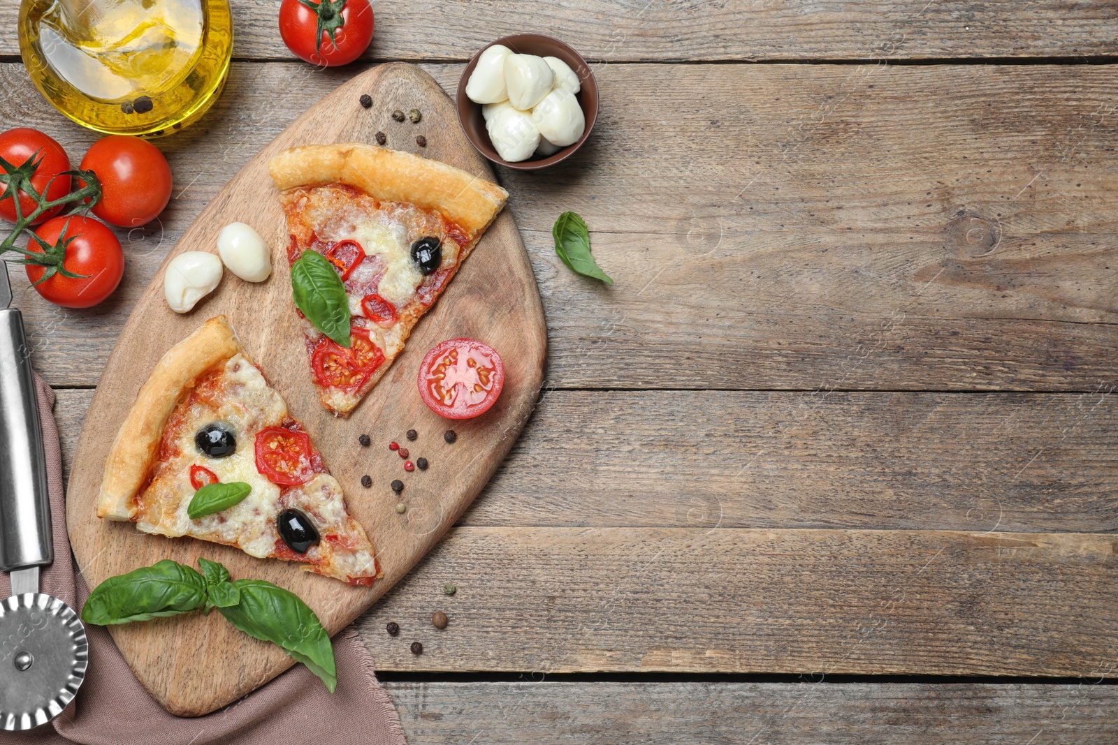 Photo of Pieces of delicious pizza Diablo on wooden table, flat lay. Space for text
