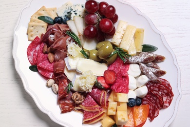 Assorted appetizers served on white wooden table, top view