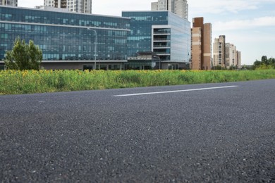 Image of Empty asphalt road and view of cityscape  