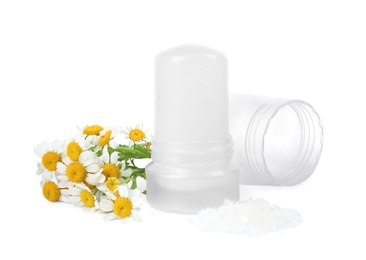 Photo of Natural crystal alum deodorant with chamomile flowers and bath salt on white background