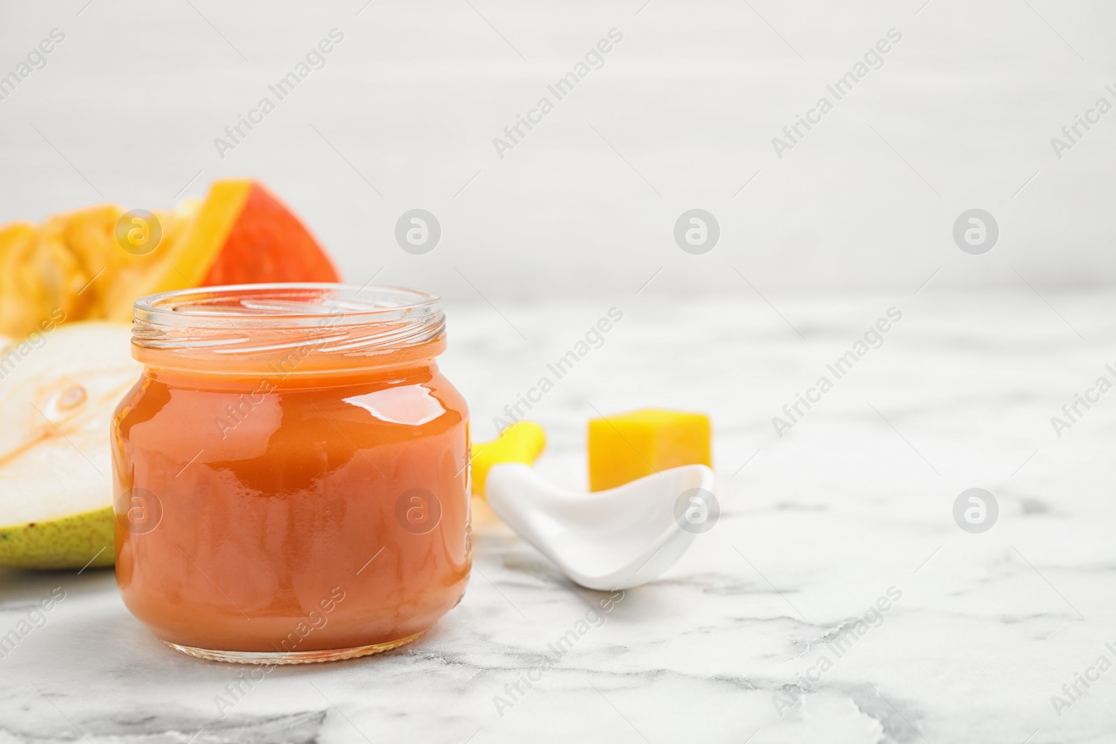 Photo of Healthy baby food and fresh ingredients on white marble table. Space for text