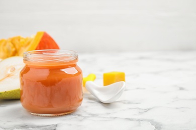 Photo of Healthy baby food and fresh ingredients on white marble table. Space for text