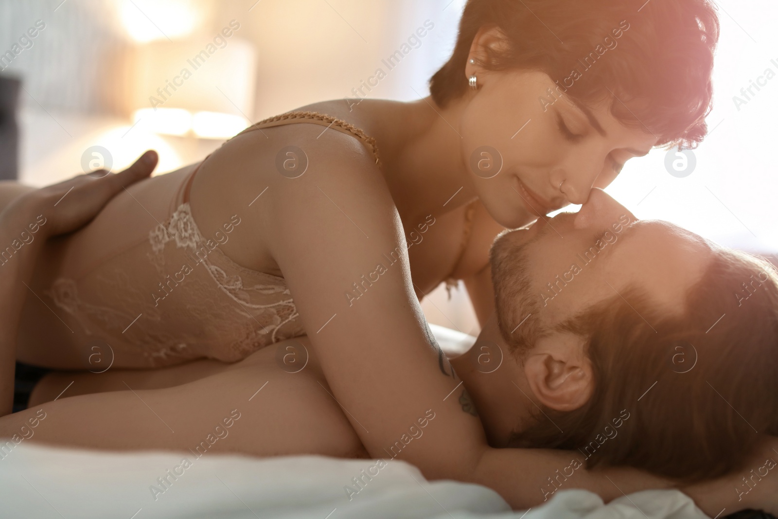 Image of Lovely young couple on bed at home