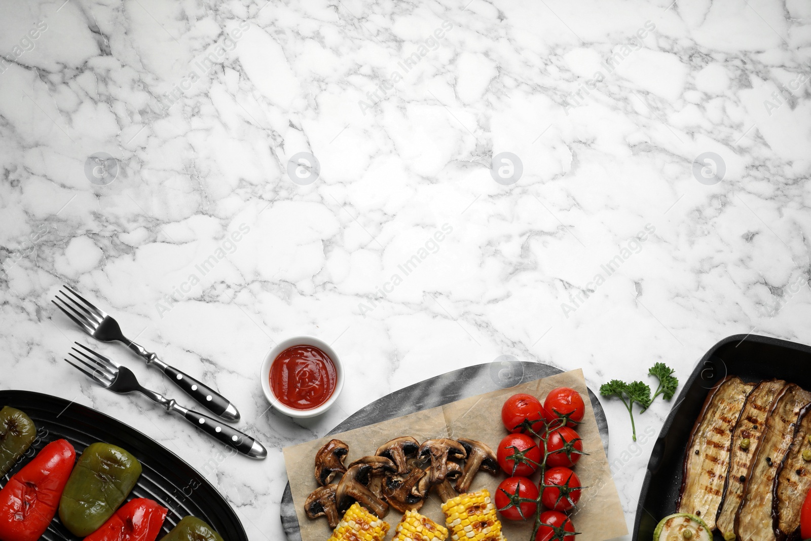 Photo of Delicious grilled vegetables served on white marble table, flat lay. Space for text