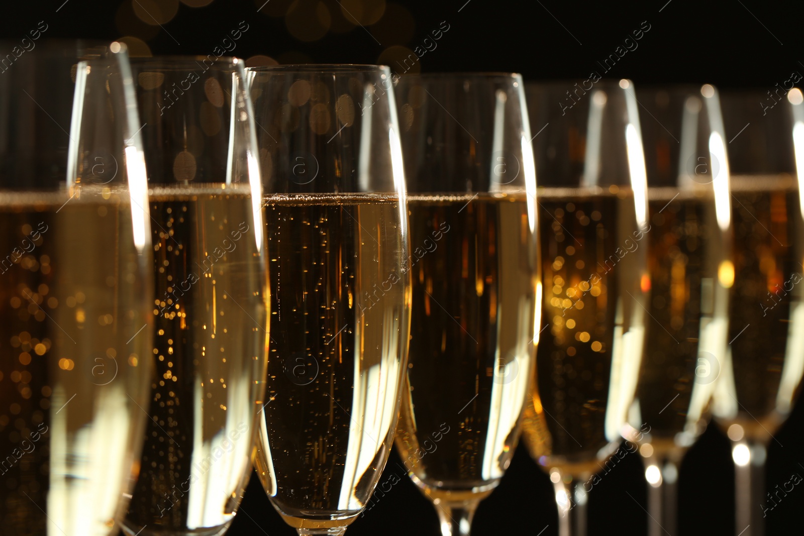 Photo of Glasses of champagne on dark background, closeup