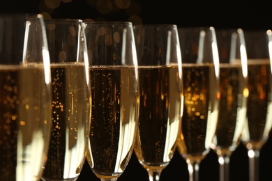 Glasses of champagne on dark background, closeup
