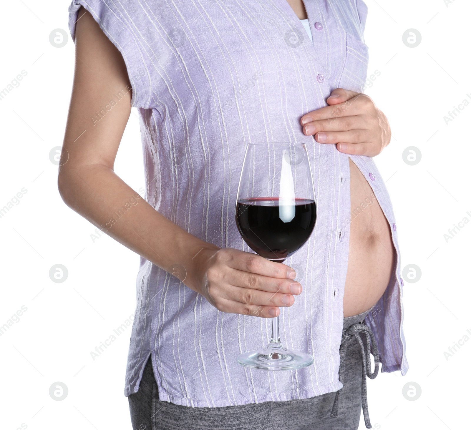 Photo of Pregnant woman with glass of red wine on white background. Alcohol addiction