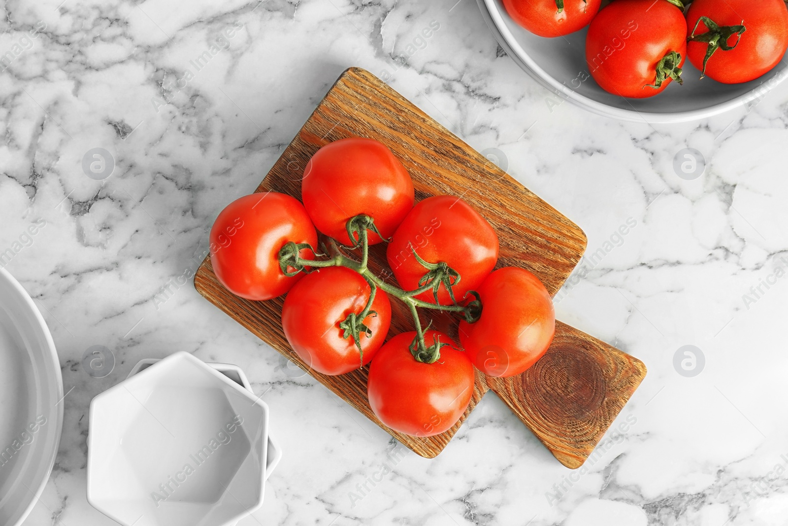 Photo of Wooden board with fresh ripe tomatoes on table, top view