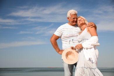 Mature couple spending time together near sea