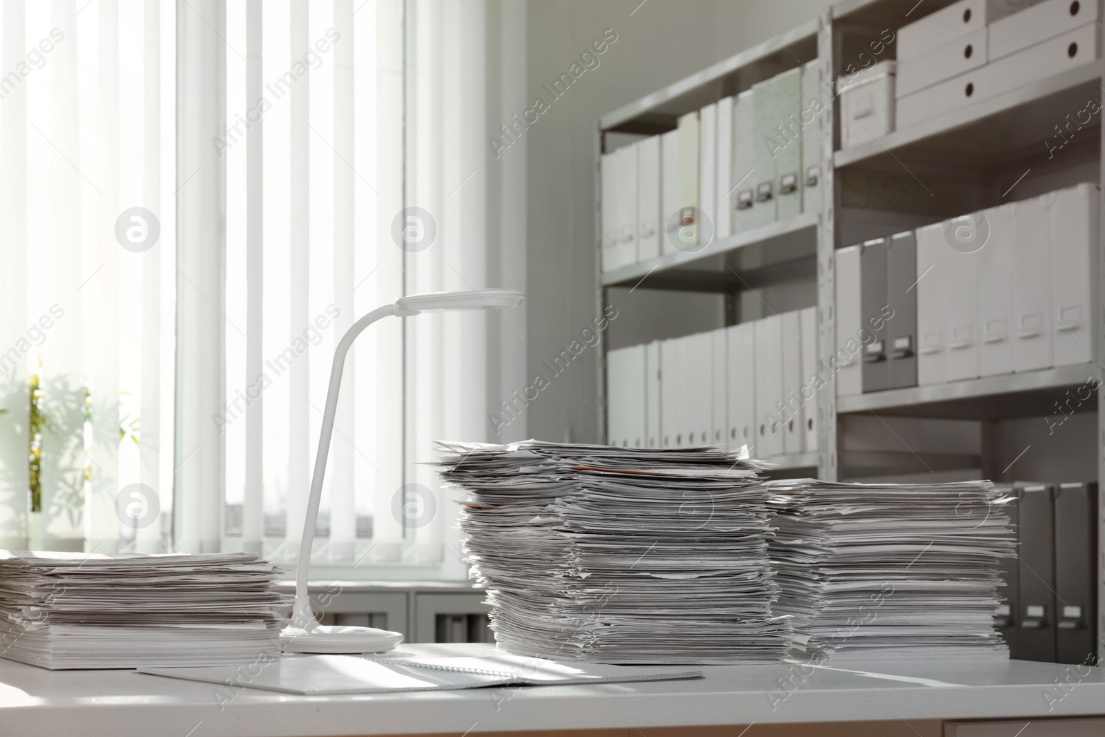 Photo of Stacks of documents on table in office