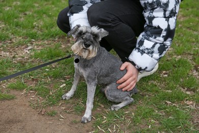 Photo of Woman with adorable Tsverkshnautser outdoors, closeup view