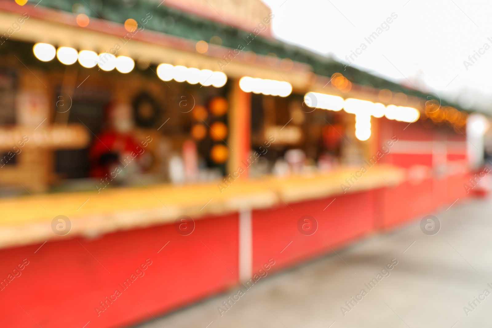 Photo of Blurred view of Christmas fair stalls outdoors