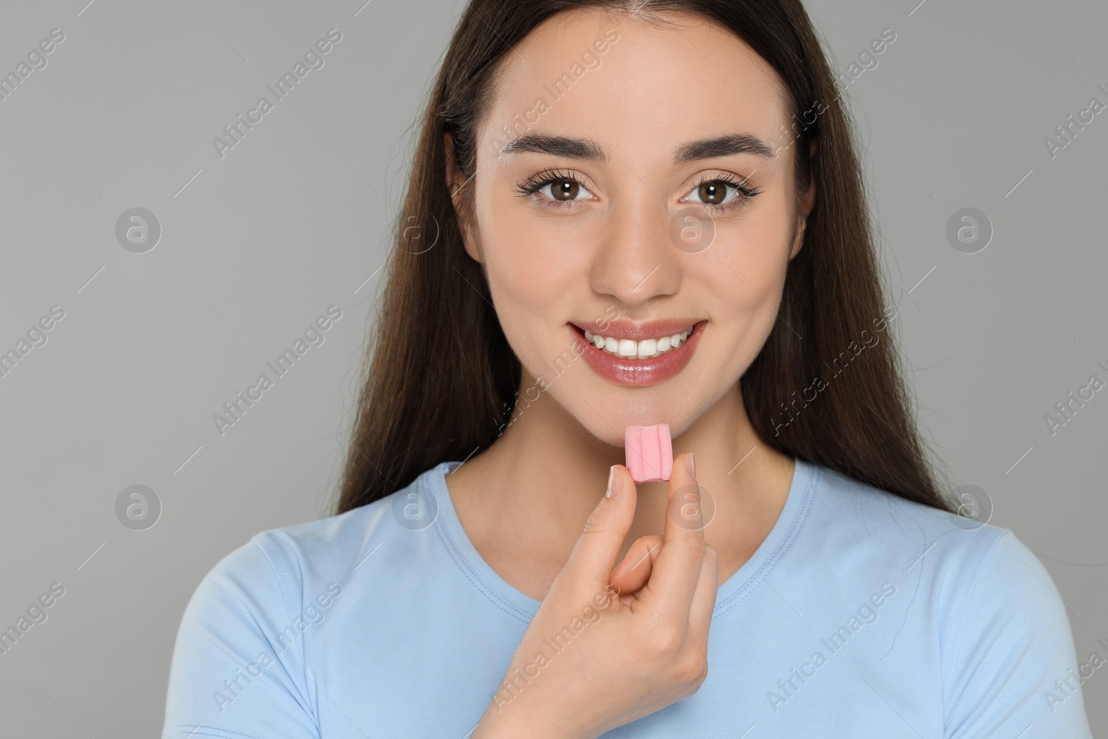 Photo of Woman with bubble gum on grey background