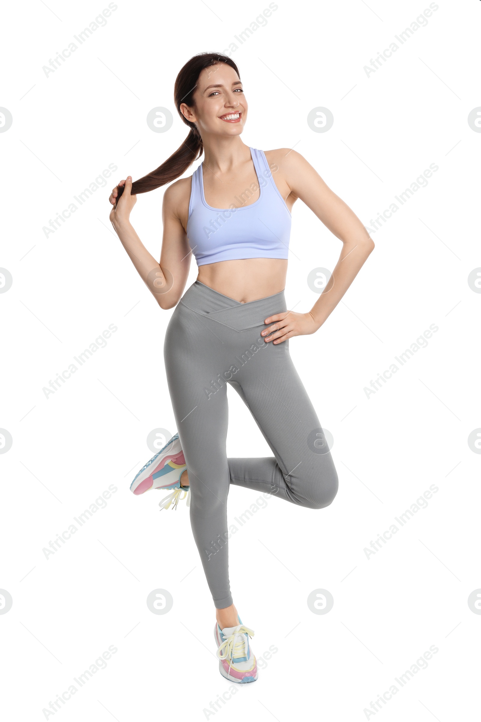 Photo of Happy young woman with slim body posing on white background