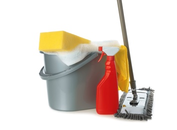 Plastic bucket with foam and cleaning supplies on white background