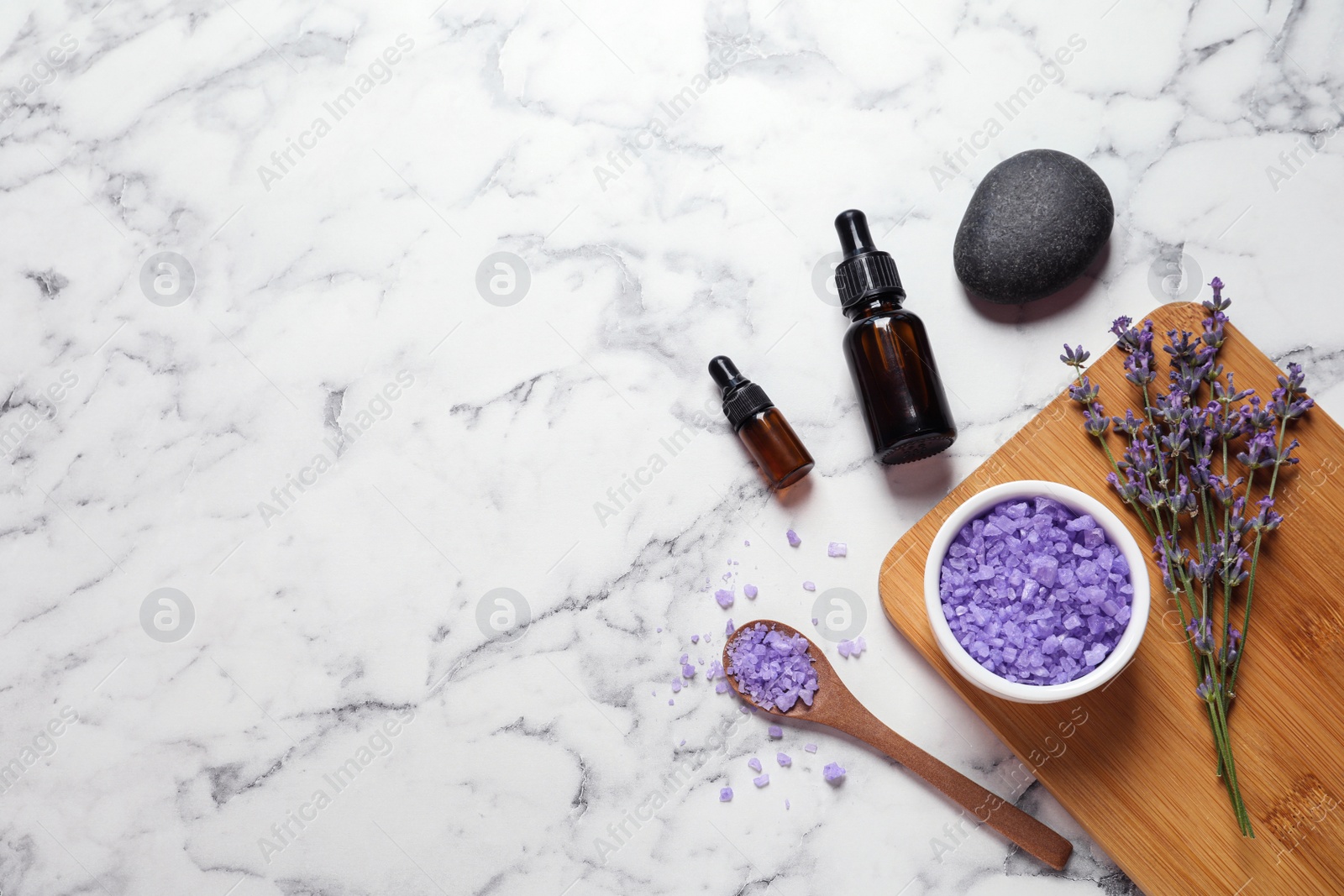 Photo of Flat lay composition with natural cosmetic products and lavender flowers on marble background. Space for text