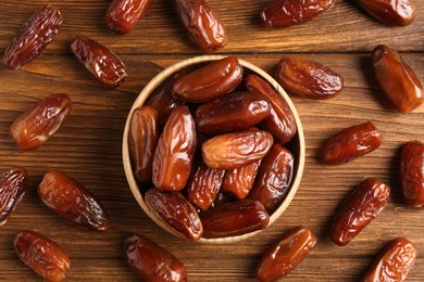 Sweet dried dates on wooden background, flat lay