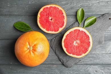 Photo of Flat lay composition with grapefruits on wooden background