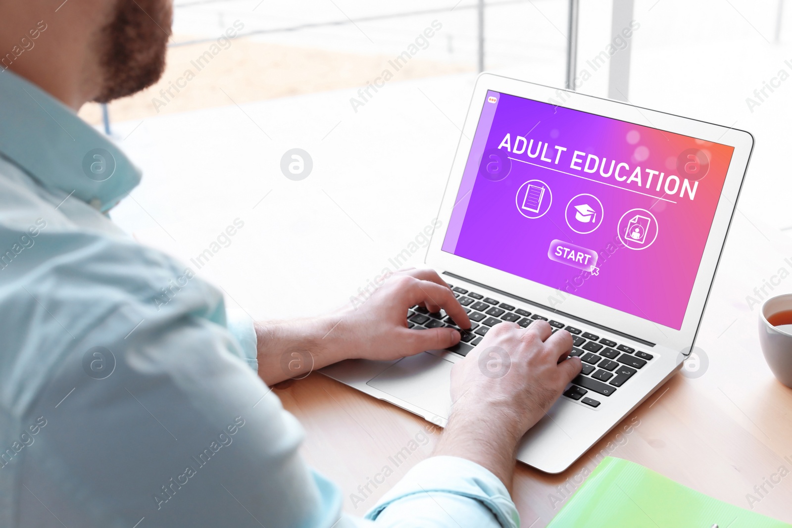 Image of Man using laptop for online studying indoors, closeup. Adult education 