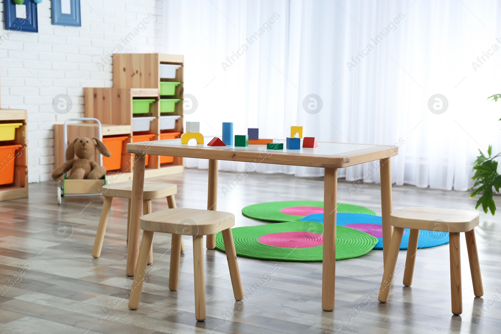 Photo of Modern child room interior with table and stools