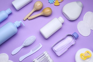 Photo of Flat lay composition with baby care products and accessories on lilac background