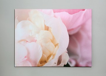 Photo of Beautiful painting of pink flower hanging on grey wall