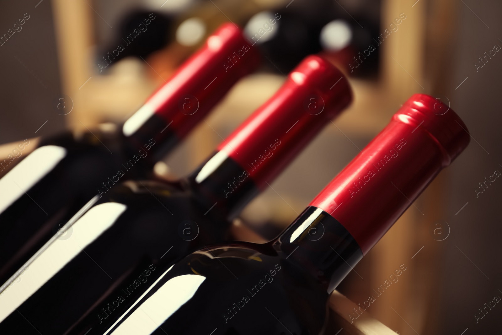 Photo of Bottles with delicious wine, closeup. Professional sommelier