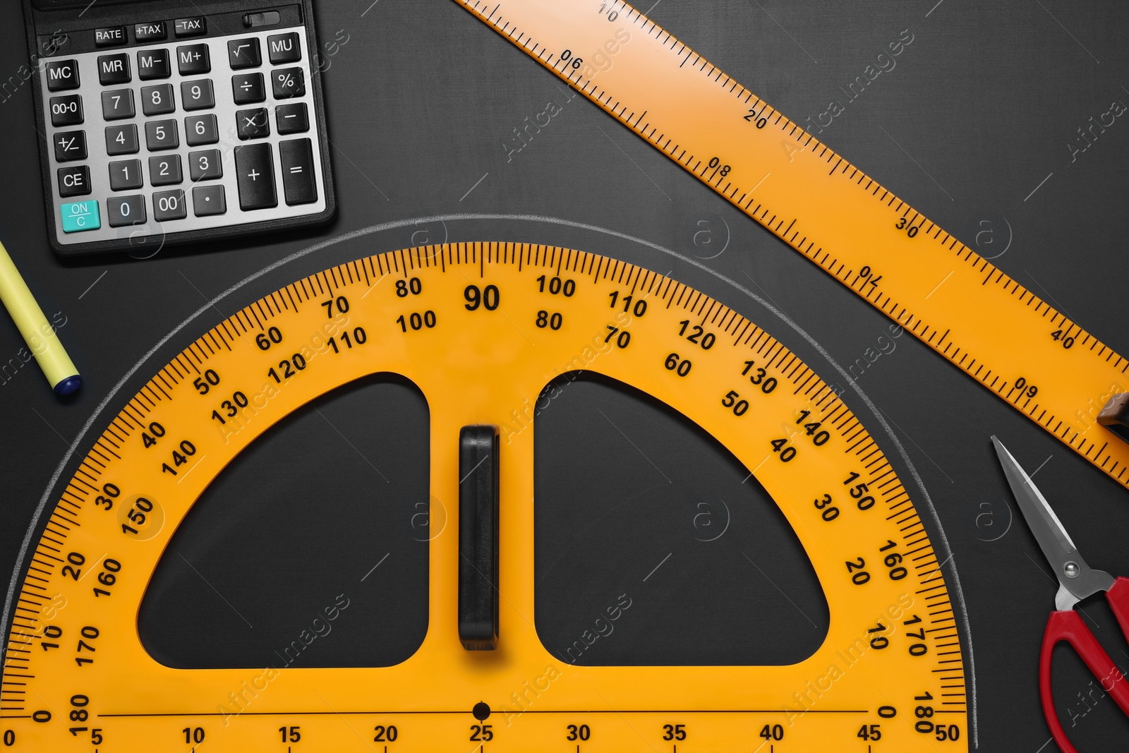 Photo of Flat lay composition with protractor and ruler on black table