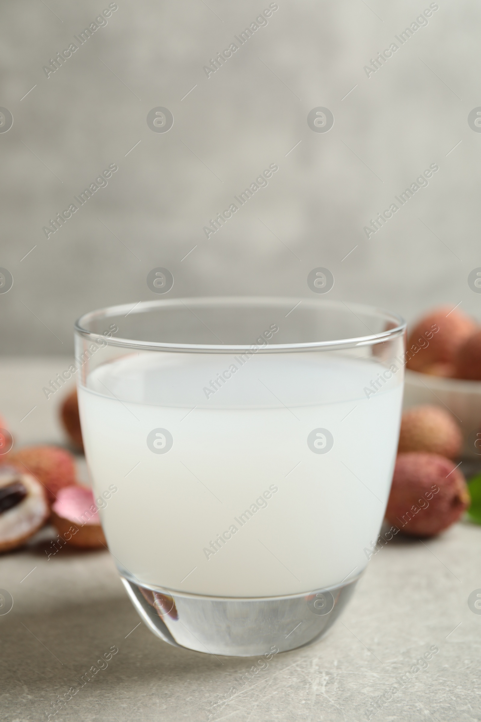 Photo of Freshly made lychee juice on light table, closeup. Space for text