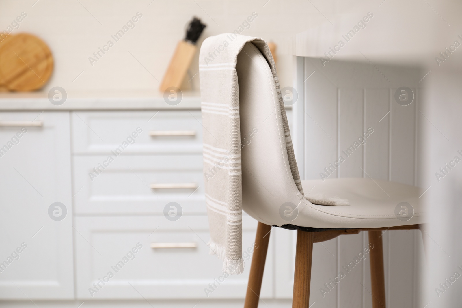 Photo of Clean kitchen towel on chair at home. Space for text