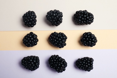 Photo of Flat lay composition with ripe blackberries on color background