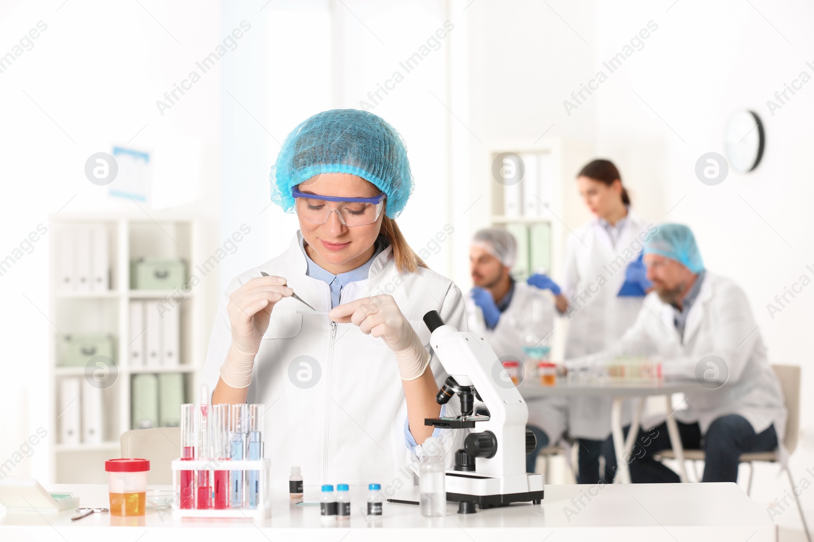 Photo of Female scientist working at table in laboratory, space for text. Research and analysis