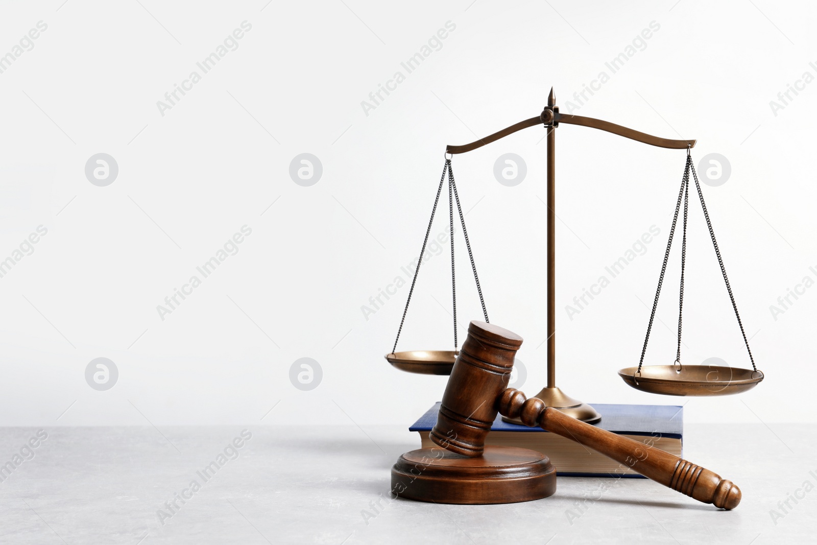 Photo of Wooden gavel, scales of justice and book on table. Law concept