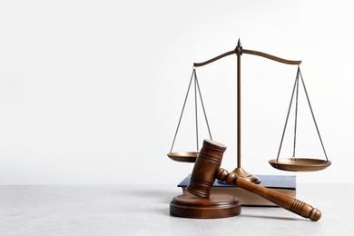 Photo of Wooden gavel, scales of justice and book on table. Law concept