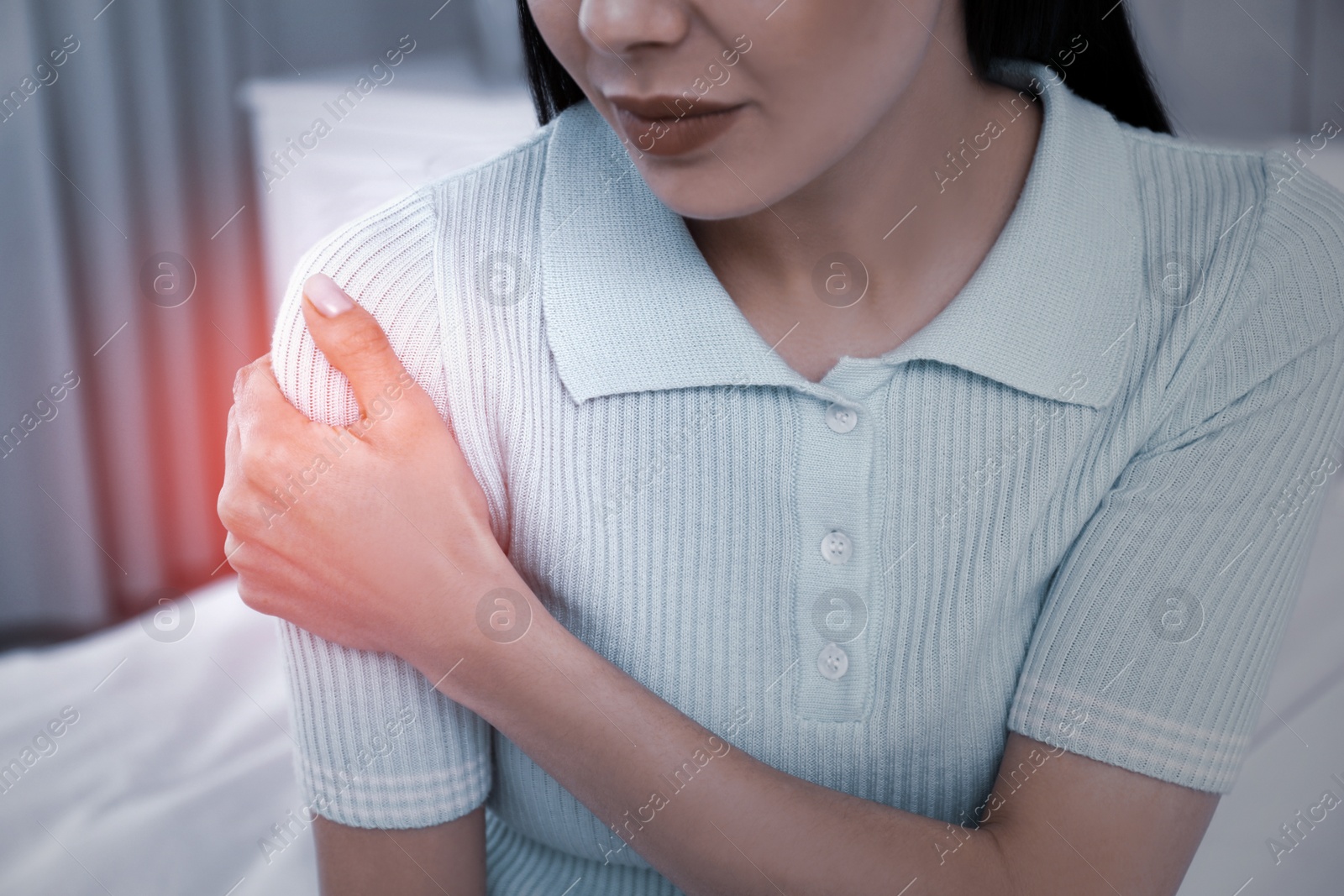 Image of Woman suffering from shoulder pain at home, closeup