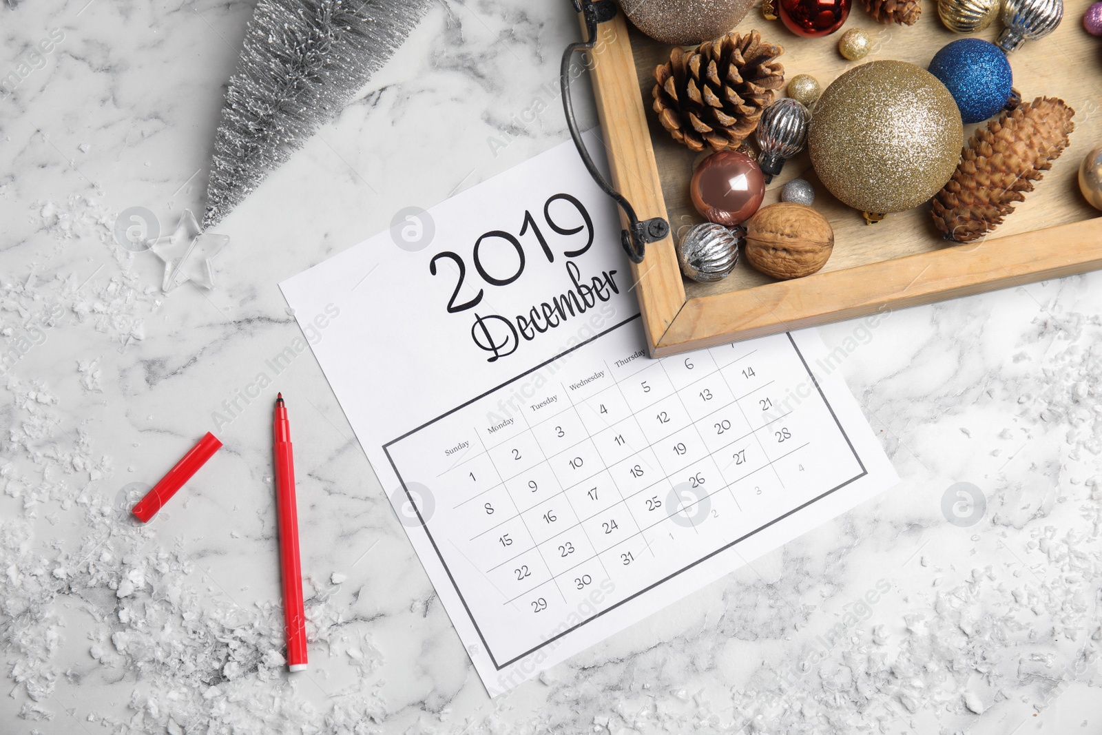 Photo of Flat lay composition with paper calendar on white marble table