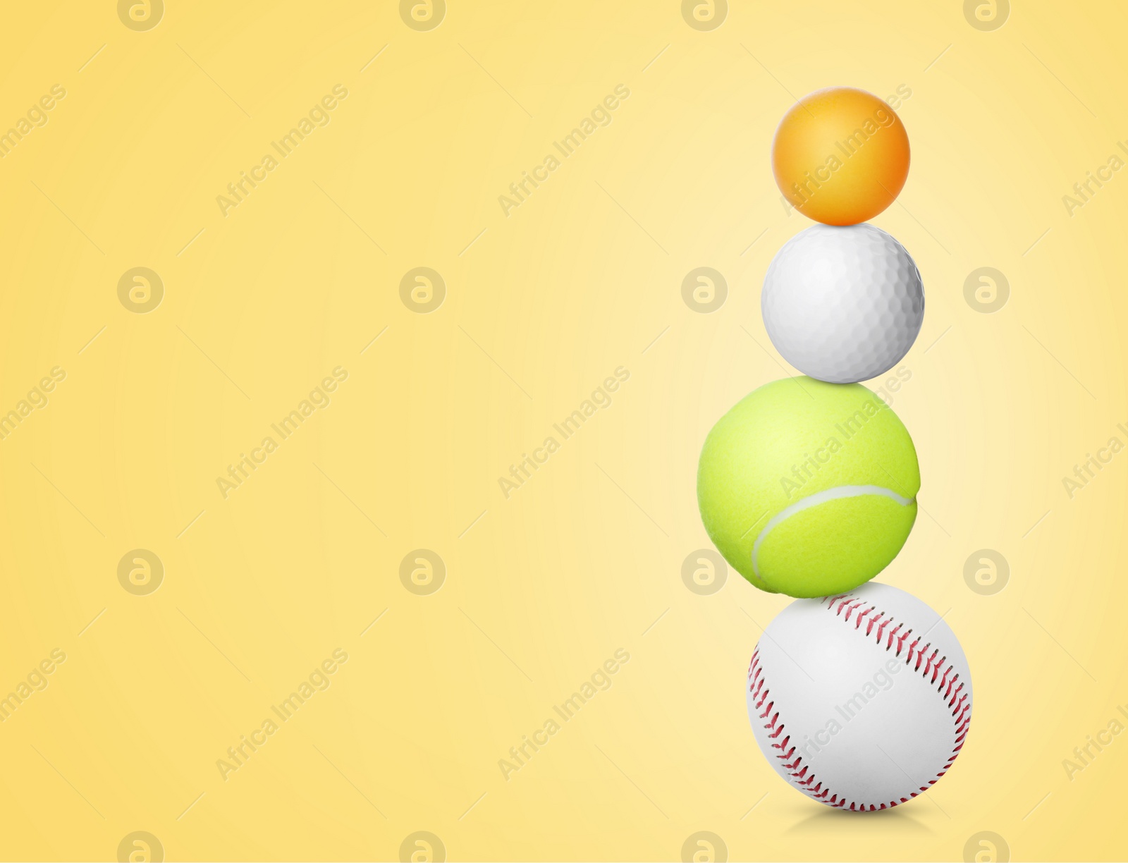 Image of Stack of different sport balls on light yellow background, space for text