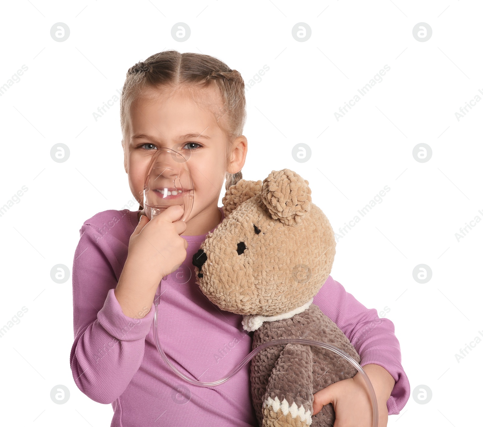 Photo of Little girl with toy bear using nebulizer for inhalation on white background