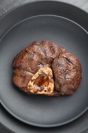 Photo of Piece of tasty grilled beef meat on plate, top view