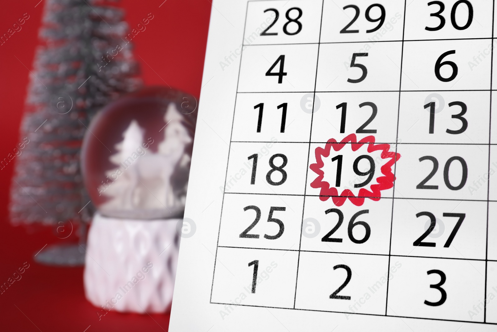 Photo of Saint Nicholas Day. Calendar with marked date December 19 and festive decor on red background, closeup